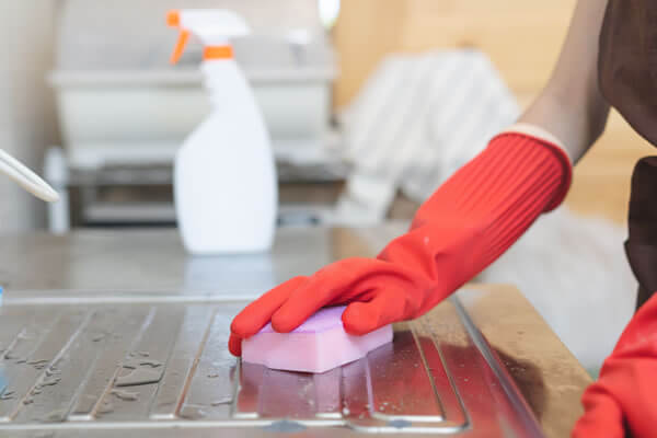 Maid Cleaning Sink